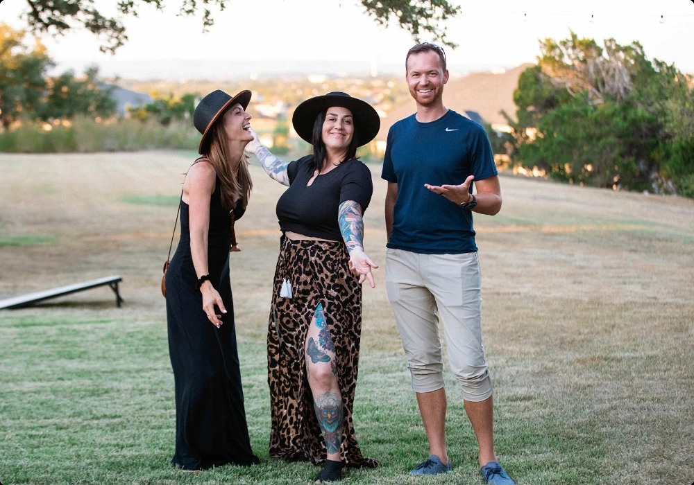 Three people playing yard games