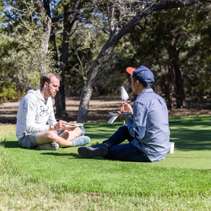 Two people chatting on a golf course